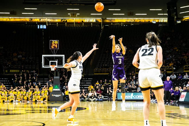 Northwestern's Sydney Wood (3) shoots a basket as Iowa's McKenna Warnock, left, defends during a NCAA Big Ten Conference women's basketball game, Wednesday, Jan. 11, 2023, at Carver-Hawkeye Arena in Iowa City, Iowa.