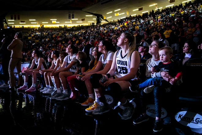 Iowa Hawkeyes players, from left, Caitlin Clark, Gabbie Marshall, Kate Martin, McKenna Warnock and Monika Czinano wait to be introduced before a NCAA Big Ten Conference women's basketball game against Northwestern, Wednesday, Jan. 11, 2023, at Carver-Hawkeye Arena in Iowa City, Iowa.