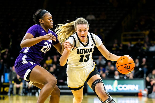 Iowa forward Shateah Wetering, right, drives to the basket as Northwestern forward Paige Mott defends during a NCAA Big Ten Conference women's basketball game, Wednesday, Jan. 11, 2023, at Carver-Hawkeye Arena in Iowa City, Iowa.