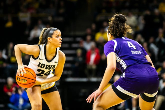 Iowa guard Gabbie Marshall (24) looks to pass as Northwestern guard Jillian Brown (4) defends during a NCAA Big Ten Conference women's basketball game, Wednesday, Jan. 11, 2023, at Carver-Hawkeye Arena in Iowa City, Iowa.