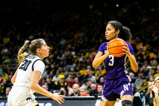Northwestern's Sydney Wood (3) looks to pass as Iowa guard Kate Martin (20) defends during a NCAA Big Ten Conference women's basketball game, Wednesday, Jan. 11, 2023, at Carver-Hawkeye Arena in Iowa City, Iowa.