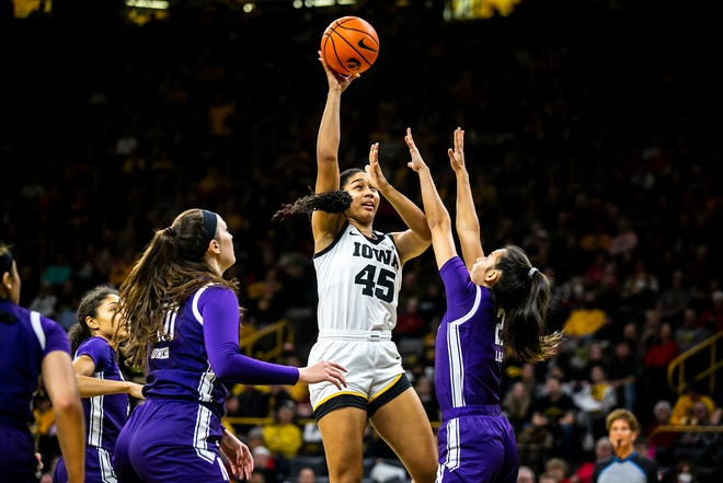Iowa forward Hannah Stuelke (45) shoots a basket as Northwestern guard Caroline Lau, right, defends during a NCAA Big Ten Conference women's basketball game, Wednesday, Jan. 11, 2023, at Carver-Hawkeye Arena in Iowa City, Iowa.