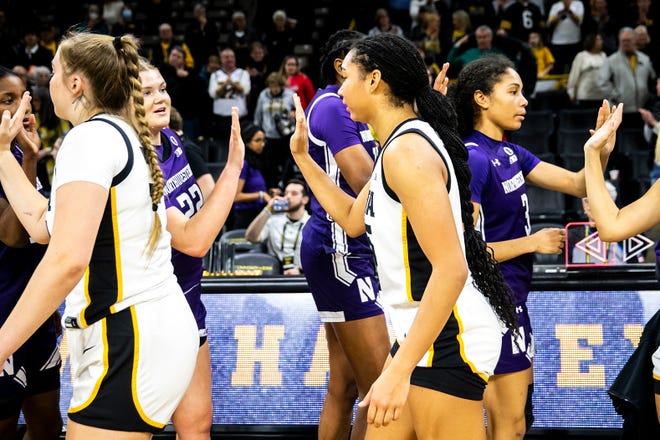 Iowa forward Hannah Stuelke, center, greets Northwestern players after a NCAA Big Ten Conference women's basketball game, Wednesday, Jan. 11, 2023, at Carver-Hawkeye Arena in Iowa City, Iowa. Iowa won, 93-64.