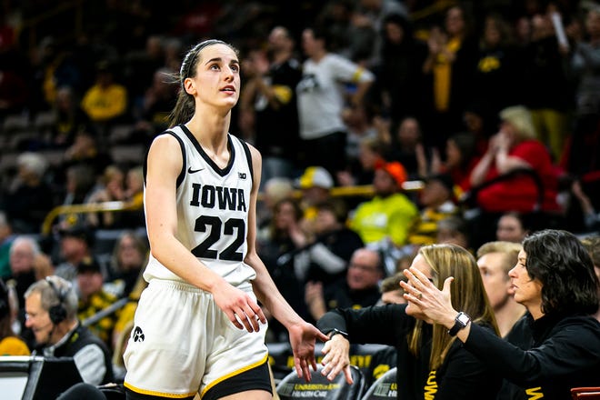 Iowa guard Caitlin Clark (22) looks up at the score board while heading to the bench during a NCAA Big Ten Conference women's basketball game against Northwestern, Wednesday, Jan. 11, 2023, at Carver-Hawkeye Arena in Iowa City, Iowa.