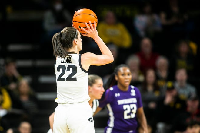 Iowa guard Caitlin Clark (22) makes a 3-point basket during a NCAA Big Ten Conference women's basketball game against Northwestern, Wednesday, Jan. 11, 2023, at Carver-Hawkeye Arena in Iowa City, Iowa.