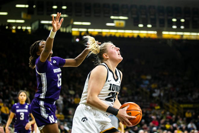 Iowa center Monika Czinano, right, shoots a basket as Northwestern forward Courtney Shaw defends during a NCAA Big Ten Conference women's basketball game, Wednesday, Jan. 11, 2023, at Carver-Hawkeye Arena in Iowa City, Iowa.
