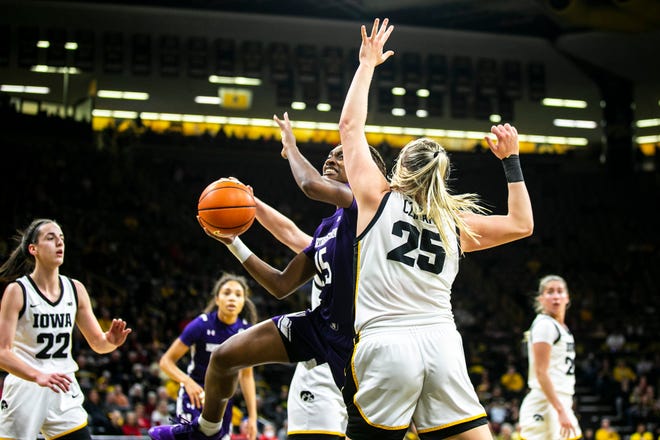 Northwestern forward Courtney Shaw (15) shoots a basket as Iowa center Monika Czinano (25) defends during a NCAA Big Ten Conference women's basketball game, Wednesday, Jan. 11, 2023, at Carver-Hawkeye Arena in Iowa City, Iowa.