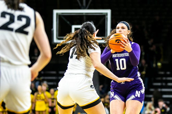 Northwestern forward Caileigh Walsh (10) shoots a basket as Iowa's McKenna Warnock (14) defends during a NCAA Big Ten Conference women's basketball game, Wednesday, Jan. 11, 2023, at Carver-Hawkeye Arena in Iowa City, Iowa.