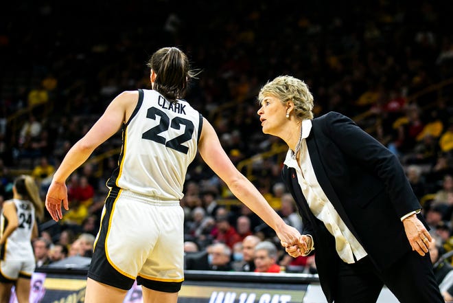Iowa head coach Lisa Bluder, right, talks with Iowa guard Caitlin Clark (22) during a NCAA Big Ten Conference women's basketball game against Northwestern, Wednesday, Jan. 11, 2023, at Carver-Hawkeye Arena in Iowa City, Iowa.
