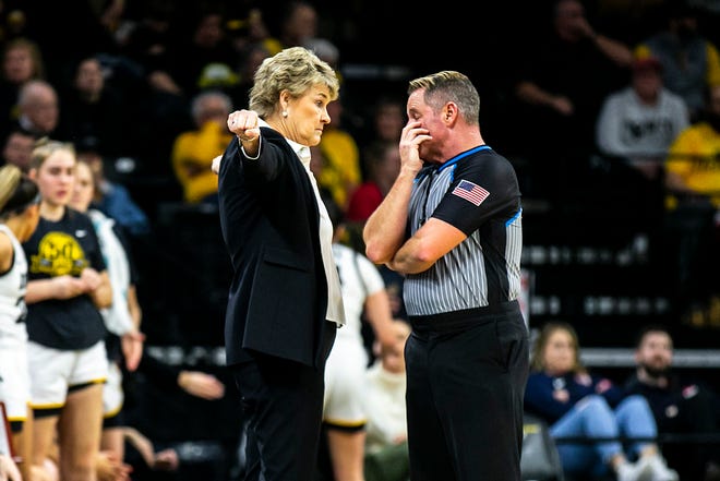 Iowa head coach Lisa Bluder, left, talks with an official during a NCAA Big Ten Conference women's basketball game against Northwestern, Wednesday, Jan. 11, 2023, at Carver-Hawkeye Arena in Iowa City, Iowa.