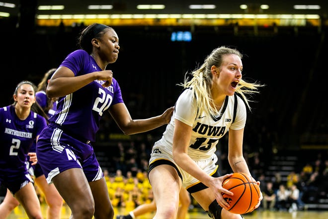 Iowa forward Shateah Wetering, right, looks to pass as Northwestern forward Paige Mott defends during a NCAA Big Ten Conference women's basketball game, Wednesday, Jan. 11, 2023, at Carver-Hawkeye Arena in Iowa City, Iowa.