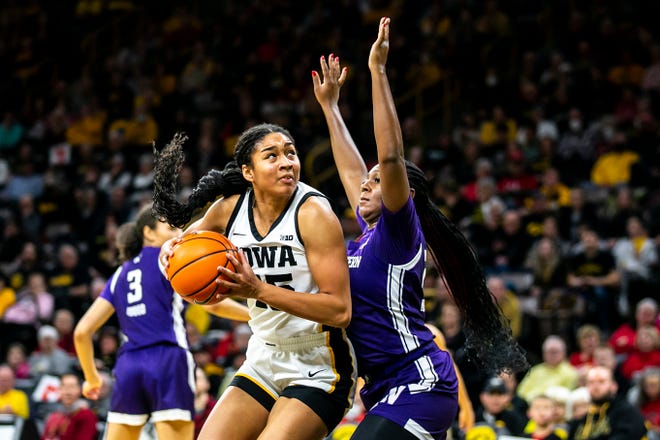 Iowa forward Hannah Stuelke, left, drives to the basket as Northwestern guard Jasmine McWilliams defends during a NCAA Big Ten Conference women ' s basketball game, Wednesday, Jan. 11, 2023, at Carver-Hawkeye Arena in Iowa City, Iowa. Iowa won, 93-64.