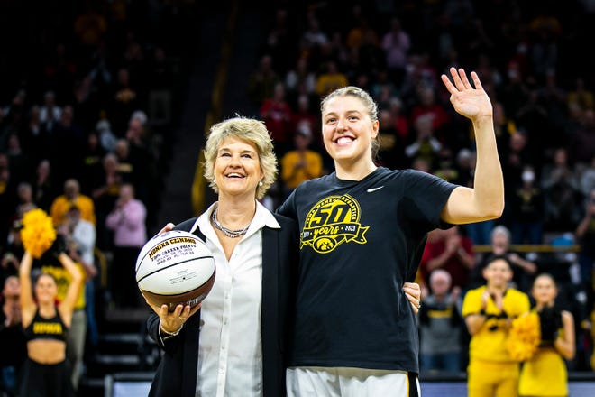 Iowa head coach Lisa Bluder, left, smiles as Iowa center Monika Czinano is presented with a basketball for her 2,000th career point before a NCAA Big Ten Conference women's basketball game against Northwesetrn, Wednesday, Jan. 11, 2023, at Carver-Hawkeye Arena in Iowa City, Iowa.
