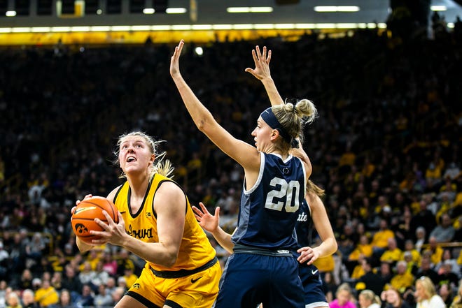 Iowa center Monika Czinano, left, drives to the basket as Penn State guard Makenna Marisa defends during a NCAA Big Ten Conference women's basketball game, Saturday, Jan. 14, 2023, at Carver-Hawkeye Arena in Iowa City, Iowa.
