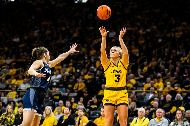 Iowa guard Sydney Affolter, right, makes a basket as Penn State guard Shay Ciezki defends during a NCAA Big Ten Conference women's basketball game, Saturday, Jan. 14, 2023, at Carver-Hawkeye Arena in Iowa City, Iowa.