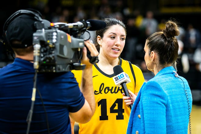 Iowa's McKenna Warnock (14) is interviewed by Meghan McKeown on the Big Ten Network after a NCAA Big Ten Conference women's basketball game against Penn State, Saturday, Jan. 14, 2023, at Carver-Hawkeye Arena in Iowa City, Iowa. Iowa won 108-67.