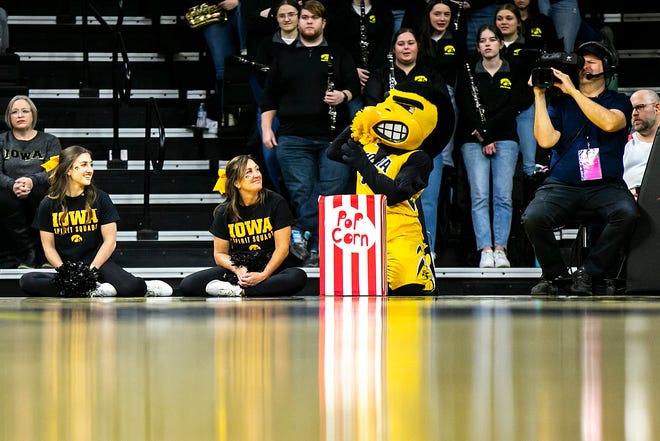University of Iowa mascot Herky the Hawk enjoys some popcorn while sitting court-side during a NCAA Big Ten Conference women's basketball game against Penn State, Saturday, Jan. 14, 2023, at Carver-Hawkeye Arena in Iowa City, Iowa.