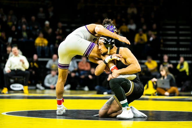 Iowa's Real Woods, right, wrestles Northwestern's Frankie Tal-Shahar at 141 pounds during a NCAA Big Ten Conference men's wrestling dual, Friday, Jan. 13, 2023, at Carver-Hawkeye Arena in Iowa City, Iowa.