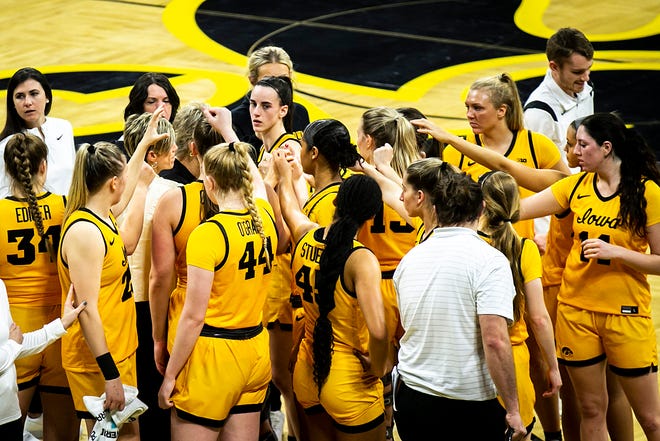 Iowa guard Caitlin Clark huddles up with teammates in a timeout during a NCAA Big Ten Conference women's basketball game against Penn State, Saturday, Jan. 14, 2023, at Carver-Hawkeye Arena in Iowa City, Iowa.