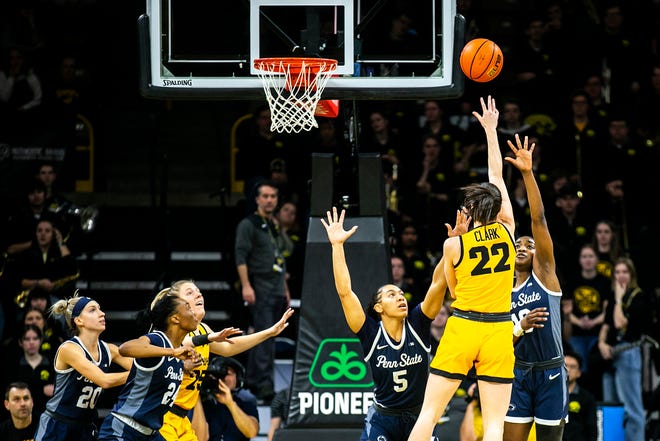 Iowa guard Caitlin Clark (22) shoots the ball as Penn State guard Leilani Kapinus (5) and forward Chanaya Pinto defend during a NCAA Big Ten Conference women's basketball game, Saturday, Jan. 14, 2023, at Carver-Hawkeye Arena in Iowa City, Iowa.