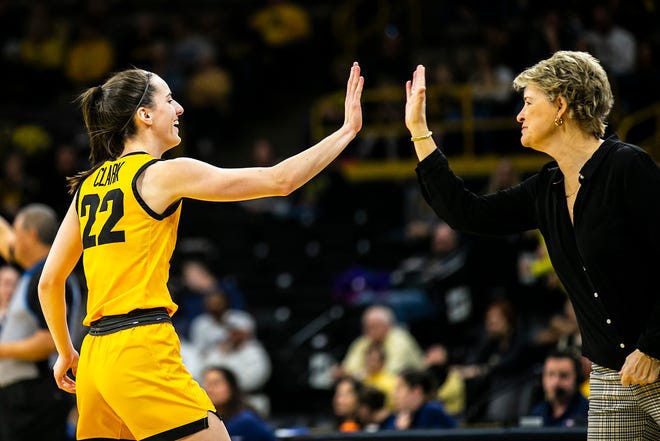 Iowa guard Caitlin Clark, left, high-fives head coach Lisa Bluder during a NCAA Big Ten Conference women's basketball game against Penn State, Saturday, Jan. 14, 2023, at Carver-Hawkeye Arena in Iowa City, Iowa.
