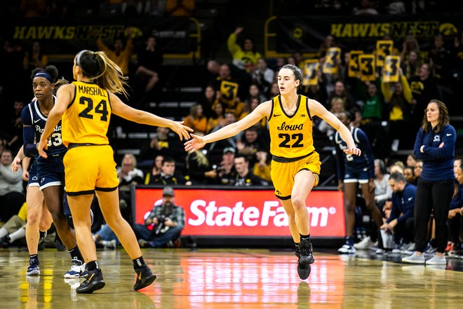 Iowa guard Caitlin Clark, right, gets a high-five from teammate Gabbie Marshall after making a 3-point basket during a NCAA Big Ten Conference women's basketball game against Penn State, Saturday, Jan. 14, 2023, at Carver-Hawkeye Arena in Iowa City, Iowa.