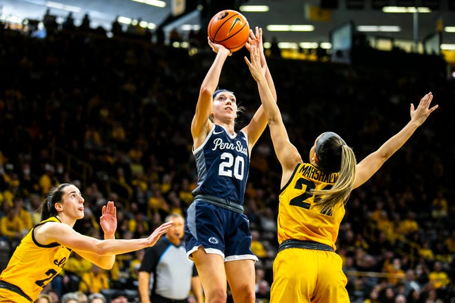 Penn State guard Makenna Marisa (20) shoots a basket as Iowa guards Caitlin Clark, left, and Gabbie Marshall defend during a NCAA Big Ten Conference women's basketball game, Saturday, Jan. 14, 2023, at Carver-Hawkeye Arena in Iowa City, Iowa.