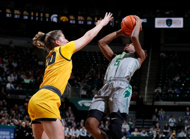 Michigan State's Kamaria McDaniel, right, shoots against Iowa's Kate Martin, Wednesday, Jan. 18, 2023, in East Lansing.
