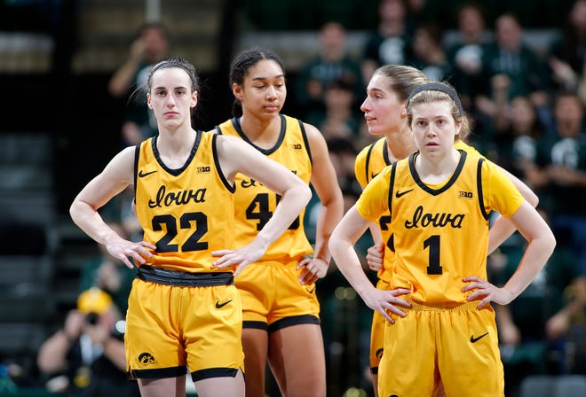 Iowa players, Caitlin Clark, from left, Hannah Stuelke, Kate Martin and Molly Davis (1) watch as Michigan State shoots free throws on an intentional foul by Clark, Wednesday, Jan. 18, 2023, in East Lansing.