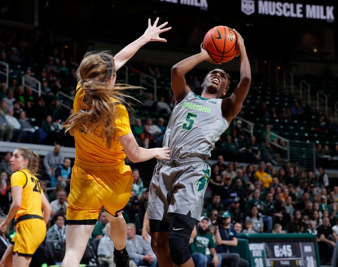 Michigan State's Kamaria McDaniel, right, shoots against Iowa's Molly Davis, Wednesday, Jan. 18, 2023, in East Lansing.