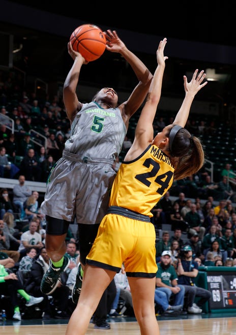 Michigan State's Kamaria McDaniel, left, goes up for a shot against Iowa's Gabbie Marshall (24), Wednesday, Jan. 18, 2023, in East Lansing.