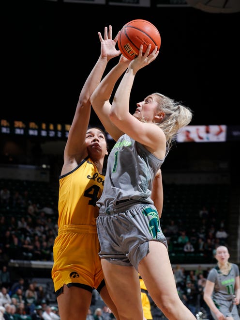 Michigan State's Tory Ozment, right, shoots against Iowa's Hannah Stuelke, Wednesday, Jan. 18, 2023, in East Lansing.