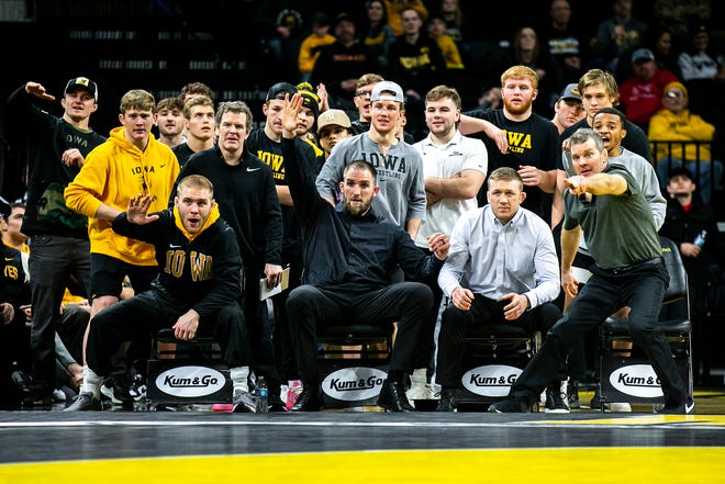 Iowa's Patrick Kennedy, seated left, watches a match with associate head coach Terry Brands, volunteer assistant coach Bobby Telford, assistant coach Ryan Morningstar and head coach Tom Brands during a Big Ten Conference men's wrestling dual against Nebraska, Friday, Jan. 20, 2023, at Carver-Hawkeye Arena in Iowa City, Iowa.