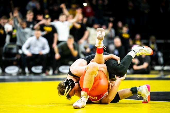 Iowa's Spencer Lee, left, wrestles Nebraska's Liam Cronin at 125 pounds during a Big Ten Conference men's wrestling dual, Friday, Jan. 20, 2023, at Carver-Hawkeye Arena in Iowa City, Iowa.