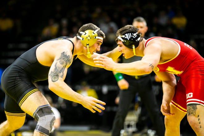Iowa's Abe Assad, left, wrestles Nebraska's Lenny Pinto at 184 pounds during a Big Ten Conference men's wrestling dual, Friday, Jan. 20, 2023, at Carver-Hawkeye Arena in Iowa City, Iowa.