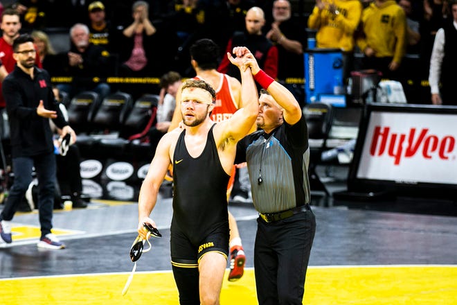 Iowa's Jacob Warner has his hand raised after scoring a decision at 197 pounds during a Big Ten Conference men's wrestling dual against Nebraska, Friday, Jan. 20, 2023, at Carver-Hawkeye Arena in Iowa City, Iowa.