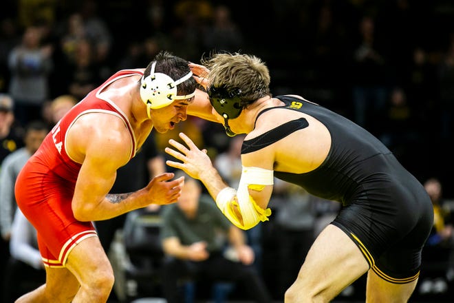 Nebraska's Mikey Labriola, left, wrestles Iowa's Nelson Brands at 174 pounds during a Big Ten Conference men's wrestling dual, Friday, Jan. 20, 2023, at Carver-Hawkeye Arena in Iowa City, Iowa.
