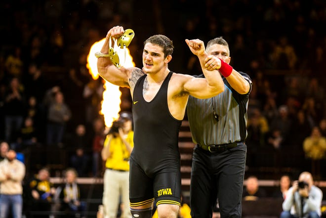 Iowa's Abe Assad flexes after scoring a decision at 184 pounds during a Big Ten Conference men's wrestling dual against Nebraska, Friday, Jan. 20, 2023, at Carver-Hawkeye Arena in Iowa City, Iowa.