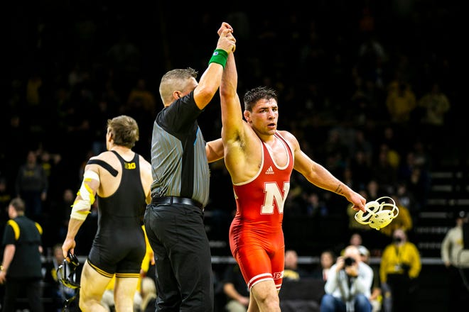 Nebraska's Mikey Labriola, right, has his hand raised after scoring a decision against Iowa's Nelson Brands at 174 pounds during a Big Ten Conference men's wrestling dual, Friday, Jan. 20, 2023, at Carver-Hawkeye Arena in Iowa City, Iowa.