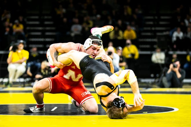 Nebraska's Mikey Labriola, left, wrestles Iowa's Nelson Brands at 174 pounds during a Big Ten Conference men's wrestling dual, Friday, Jan. 20, 2023, at Carver-Hawkeye Arena in Iowa City, Iowa.