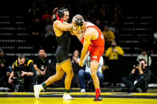Iowa's Real Woods, left, wrestles Nebraska's Brock Hardy at 141 pounds during a Big Ten Conference men's wrestling dual, Friday, Jan. 20, 2023, at Carver-Hawkeye Arena in Iowa City, Iowa.