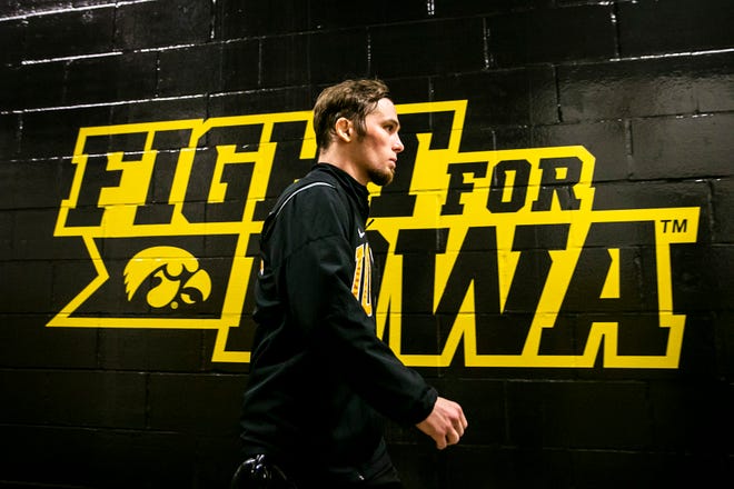 Iowa's Spencer Lee walks down to the mat to be introduced before wrestling at 125 pounds during a Big Ten Conference men's wrestling dual against Nebraska, Friday, Jan. 20, 2023, at Carver-Hawkeye Arena in Iowa City, Iowa.