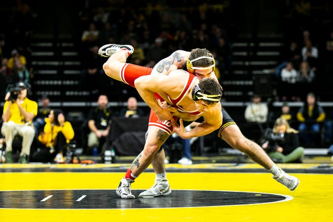 Iowa's Abe Assad, right, wrestles Nebraska's Lenny Pinto at 184 pounds during a Big Ten Conference men's wrestling dual, Friday, Jan. 20, 2023, at Carver-Hawkeye Arena in Iowa City, Iowa.