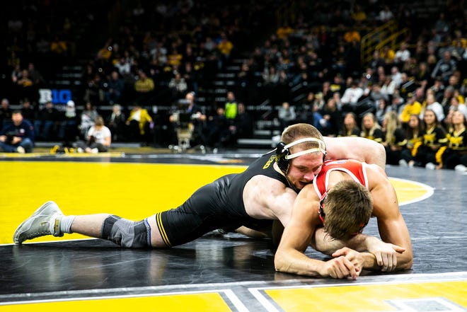 Iowa's Patrick Kennedy, left, wrestles Nebraska's Bubba Wilson at 165 pounds during a Big Ten Conference men's wrestling dual, Friday, Jan. 20, 2023, at Carver-Hawkeye Arena in Iowa City, Iowa.