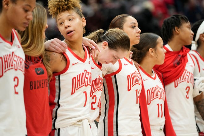 Jan 23, 2023; Columbus, OH, USA;  Ohio State Buckeyes guard Taylor Mikesell (24) hangs her head during "Carmen Ohio" following the NCAA women's basketball game against the Iowa Hawkeyes at Value City Arena. Ohio State lost 83-72. Mandatory Credit: Adam Cairns-The Columbus Dispatch