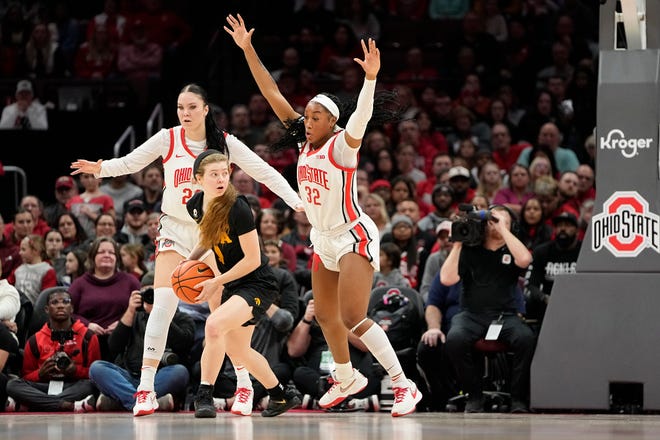 Jan 23, 2023; Columbus, OH, USA;  Ohio State Buckeyes forward Cotie McMahon (32) and forward Rebeka Mikulasikova (23) defend Iowa Hawkeyes guard Molly Davis (1) during the first half of the NCAA women's basketball game against the Ohio State Buckeyes at Value City Arena. Mandatory Credit: Adam Cairns-The Columbus Dispatch