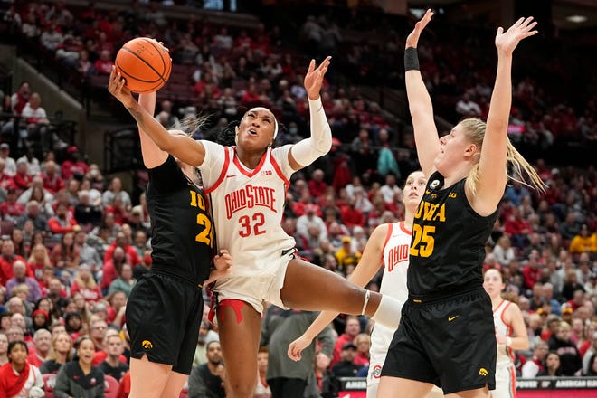 Jan 23, 2023; Columbus, OH, USA;  Ohio State Buckeyes forward Cotie McMahon (32) draws contact from Iowa Hawkeyes forward Monika Czinano (25) during the second half of the NCAA women's basketball game at Value City Arena. Ohio State lost 83-72. Mandatory Credit: Adam Cairns-The Columbus Dispatch