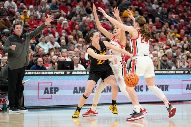 Jan 23, 2023; Columbus, OH, USA;  Ohio State Buckeyes guard Emma Shumate (5) and guard Taylor Mikesell (24) defend Iowa Hawkeyes guard Caitlin Clark (22) during the second half of the NCAA women's basketball game at Value City Arena. Ohio State lost 83-72. Mandatory Credit: Adam Cairns-The Columbus Dispatch