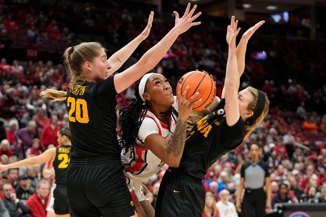 Jan 23, 2023; Columbus, OH, USA;  Ohio State Buckeyes forward Cotie McMahon (32) shoots between Iowa Hawkeyes guard Kate Martin (20) and guard Molly Davis (1) during the first half of the NCAA women's basketball game at Value City Arena. Mandatory Credit: Adam Cairns-The Columbus Dispatch