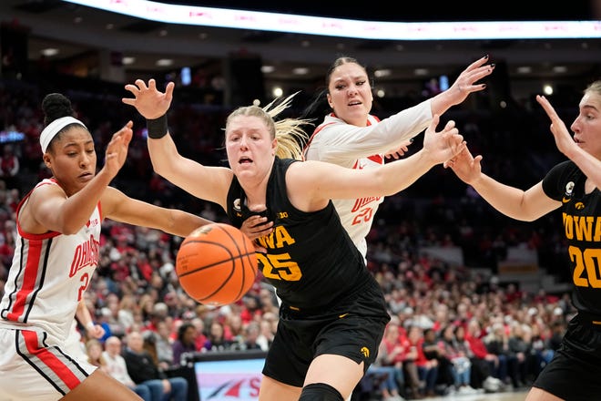 Jan 23, 2023; Columbus, OH, USA;  Ohio State Buckeyes forward Taylor Thierry (2) and Iowa Hawkeyes forward Monika Czinano (25) scramble for a loose ball during the first half of the NCAA women's basketball game at Value City Arena. Mandatory Credit: Adam Cairns-The Columbus Dispatch